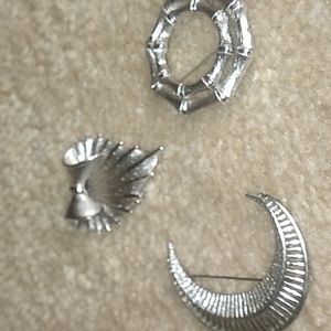 A SET OF 3 SILVER TONE SIGNED PINS.CORO, MONET, SAR COV SB10